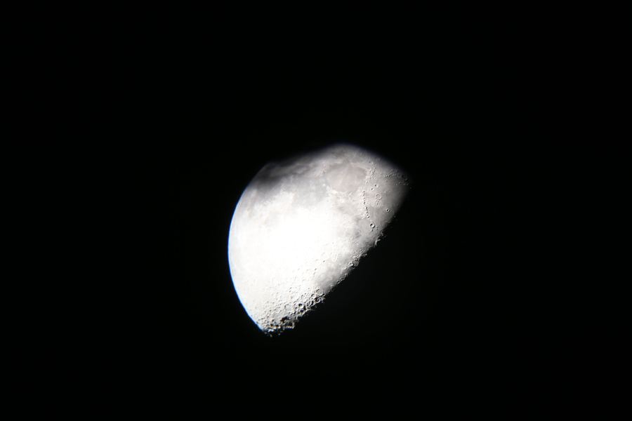 A waxing gibbous moon against a black sky, craters picked out along the terminator.